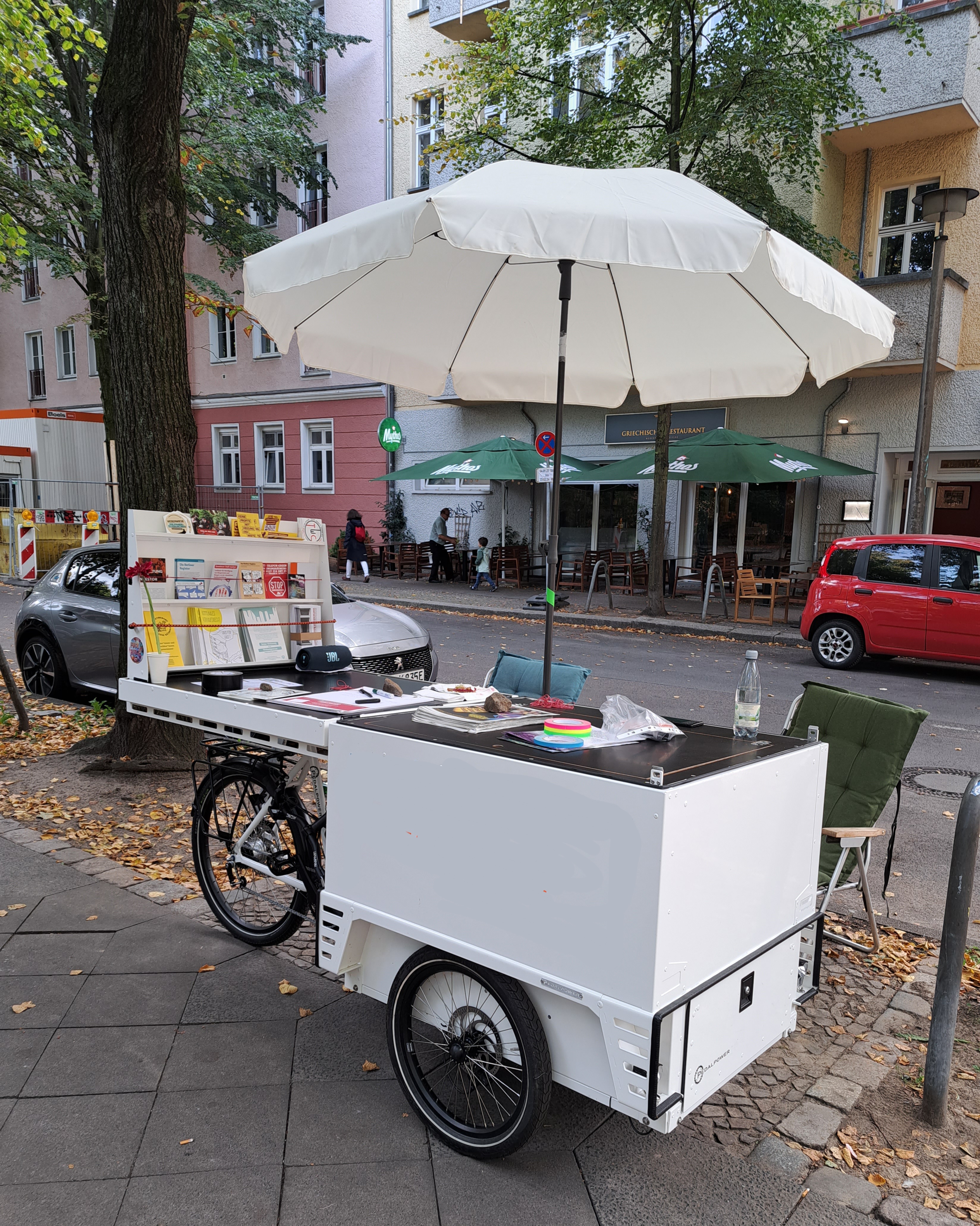 Foto vom mobilen Infostand - mit aufgeklapptem Schirm und vielen Info-Flyern